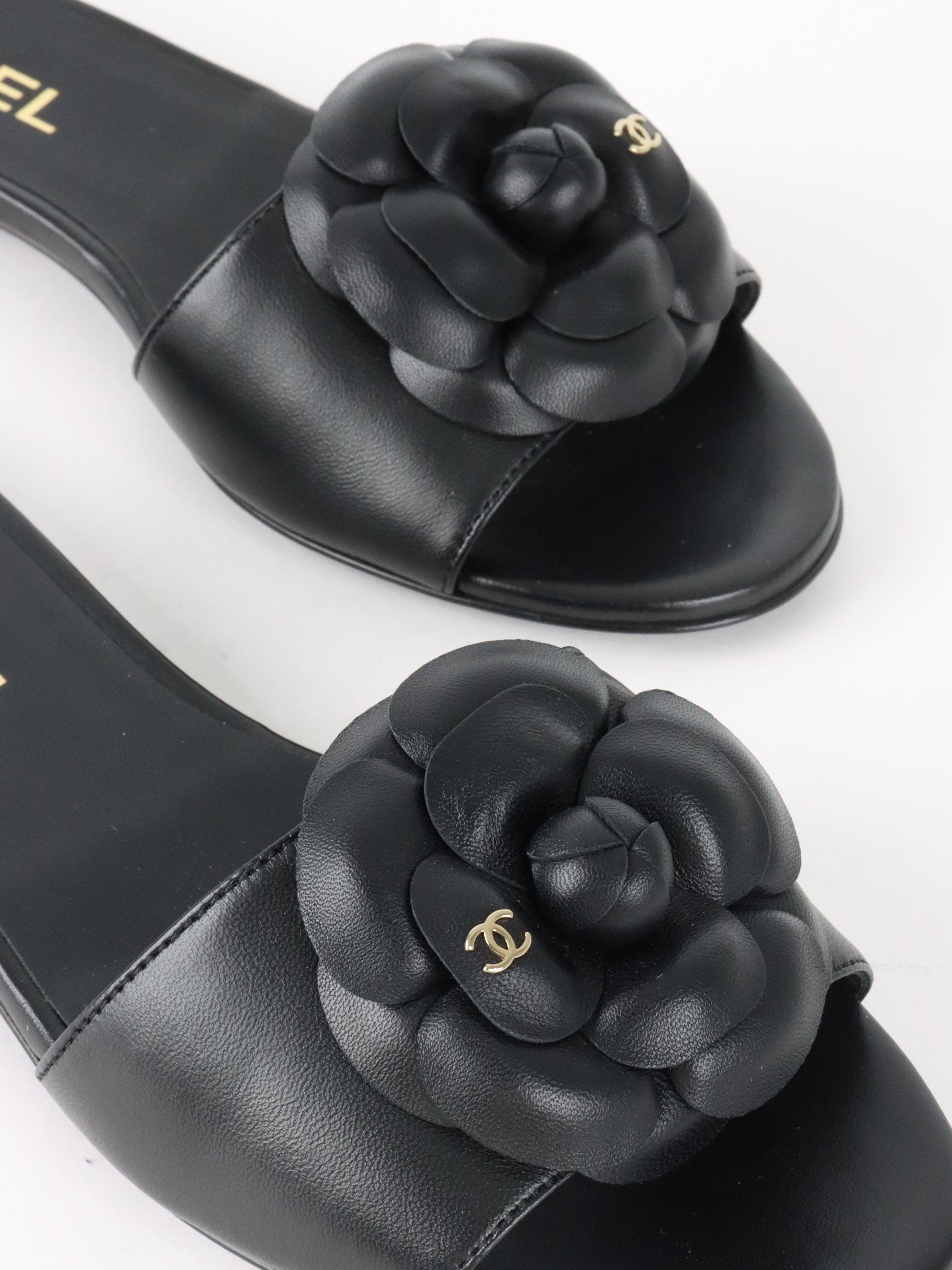 Chanel Black Camellia Slide Sandals.